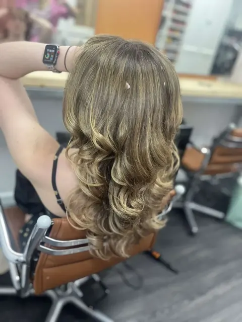 Long blonde waves viewed from behind
