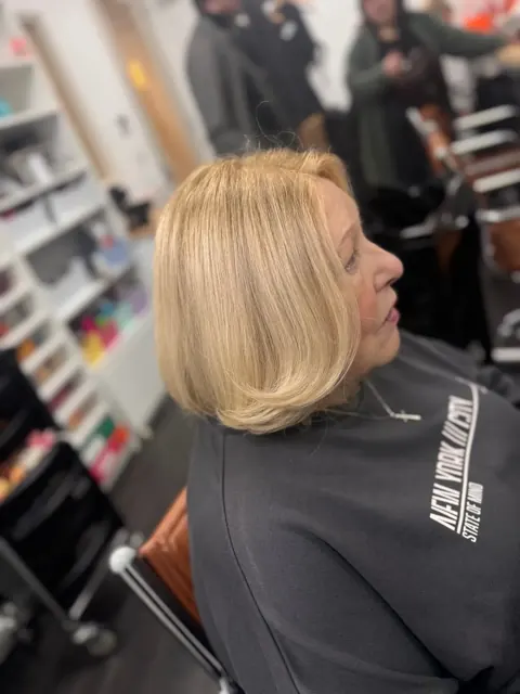 Blonde waves being styled