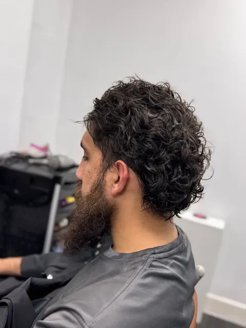 Dark curly hair viewed from the side